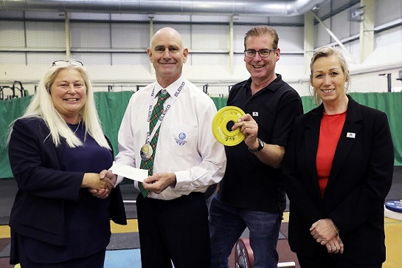 Chris Baker presenting cheque to Sam Hughes